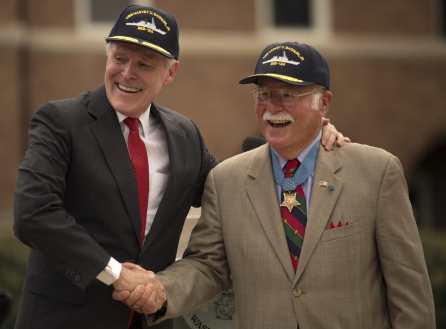 Secretary of Navy Ray Mabus (left) congratulates Barney Barnum ’62 (right).