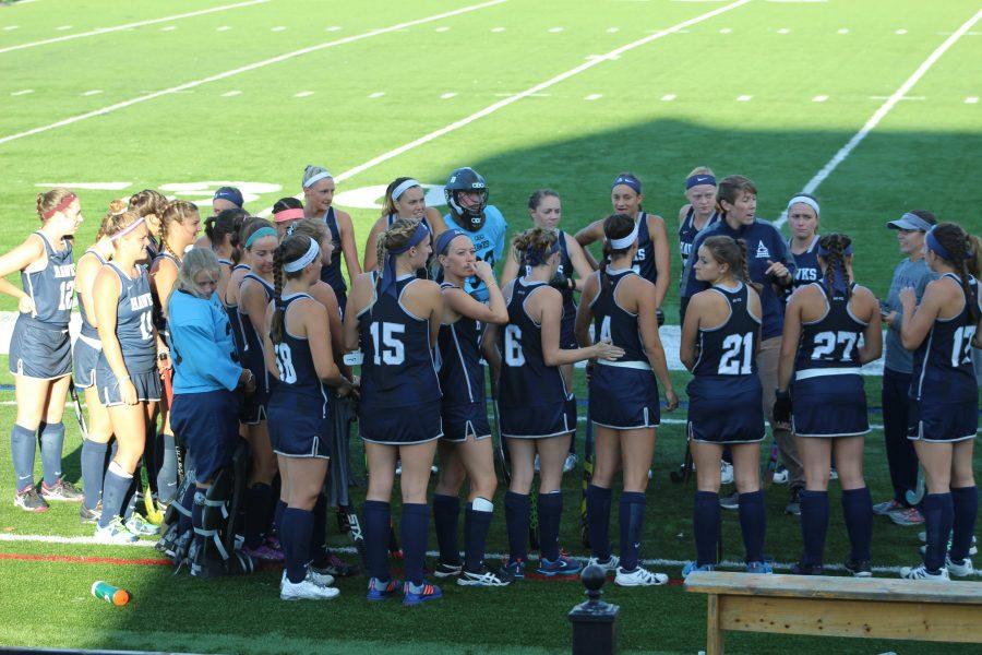 Field hockey discussing game plan in a home contest versus St. Thomas Aquinas.