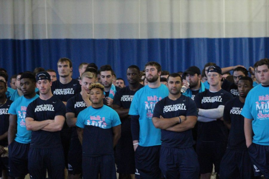 Hawks football team stands against sexual assault at Enough is Enough event.