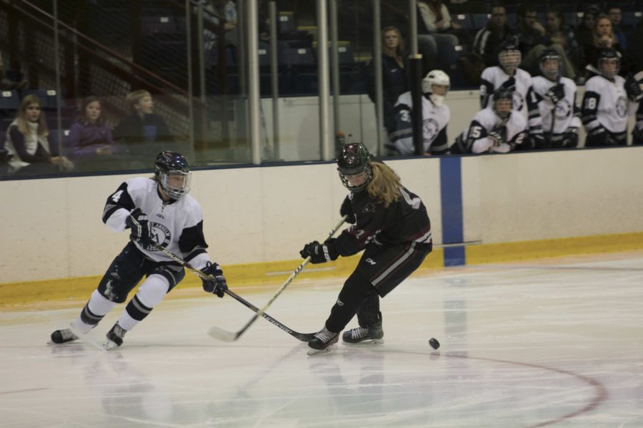 Sophomore+Sara+McNamara+looking+for+a+loose+puck+in+team%E2%80%99s+opener+on+Oct+28.