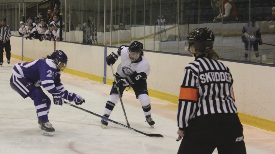 Senior Alex Starzyk controls the puck in an NEHC contest against Holey Cross on Dec. 2.