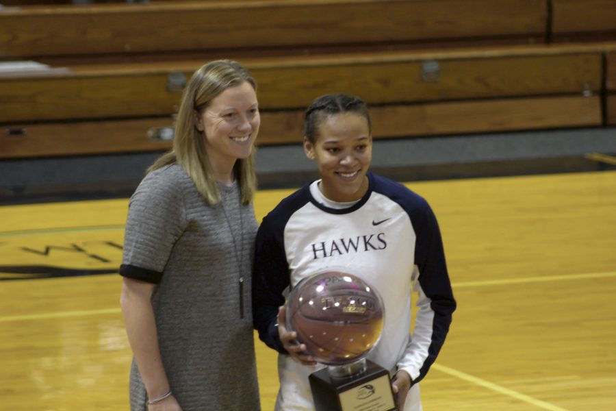 Senior+Candace+Andrews+receives+award+for+1000+points+from+head+coach+Julie+Plant.