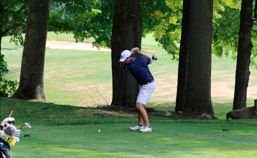 Senior Nick Markham keeps his eye on the ball as he aims for the fairway.