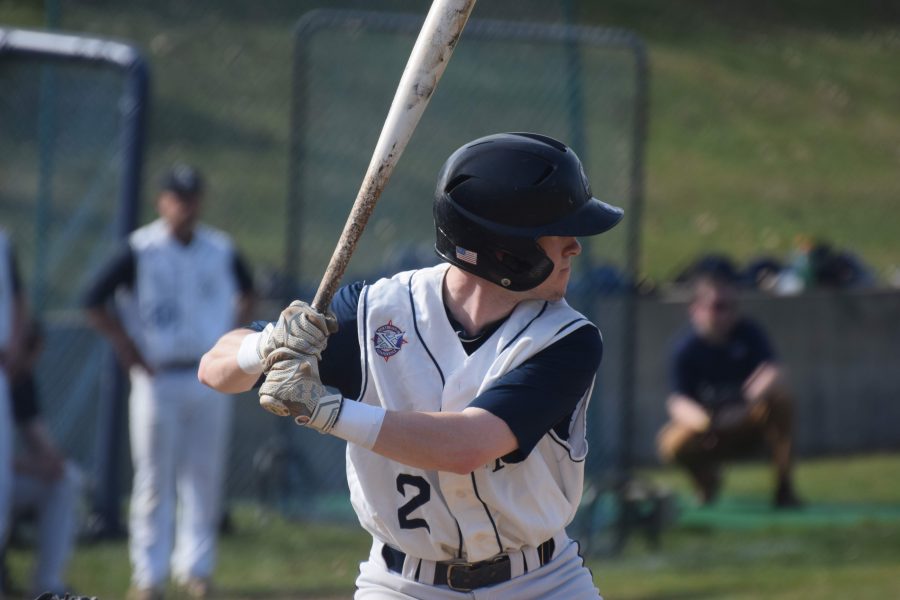 Senior+Matthew+Flynn+stands+over+home+plate+as+he+prepares+for+his+pitch.