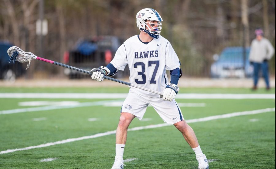 Bourdeau on field for the Hawks, looks to pass the ball upfield.