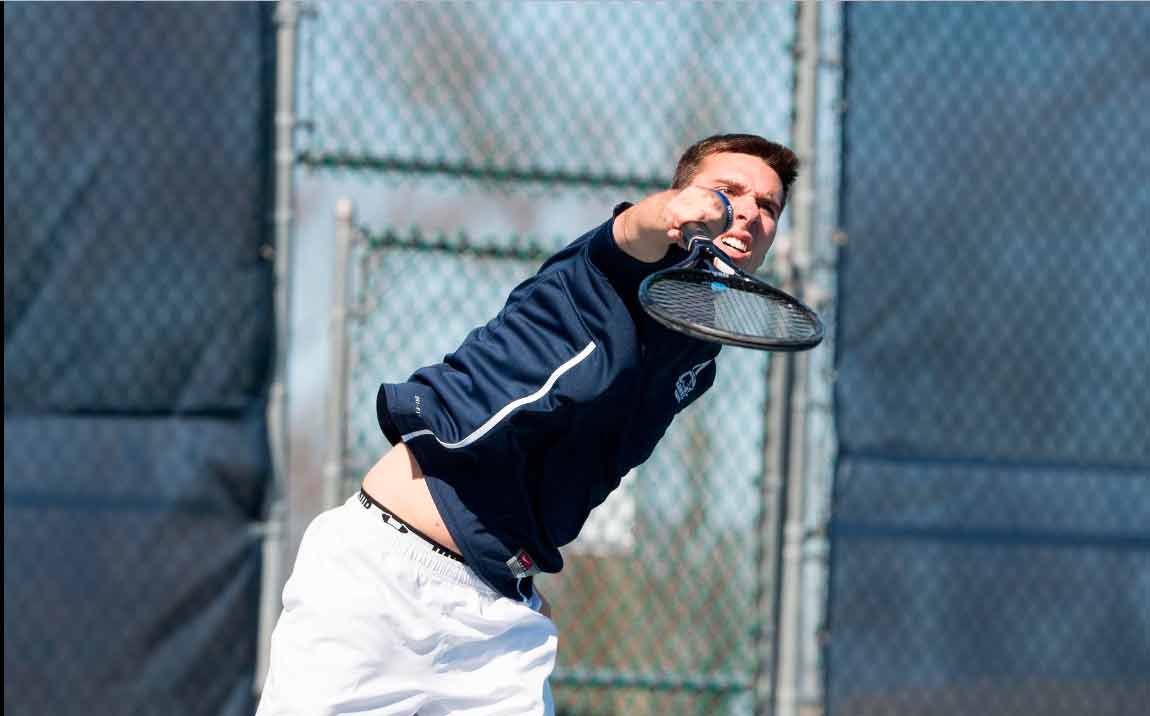 Harris is seen here firing a powerful serve at his opponent.