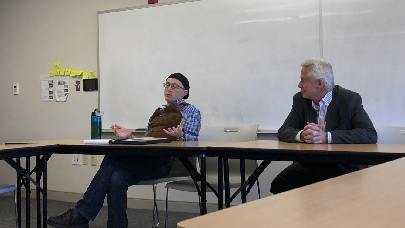 Professor Bouchard (right) listens intently as Professor Durham (left) discusses his perspective on science and truth.