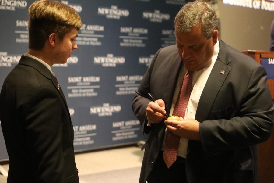 Chris Christie signs egg at Politics and Eggs with NHIOP ambassador, Brenden Fedrezzi