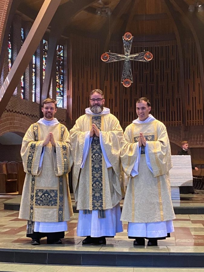 Father Titus, Father Francis, and Father Basil stand together in the Abbey after their ordination
