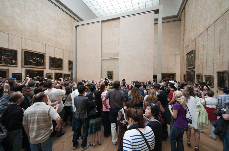 Crowds joyously wait for a chance to view the Mona Lisa, a true artistic masterpiece