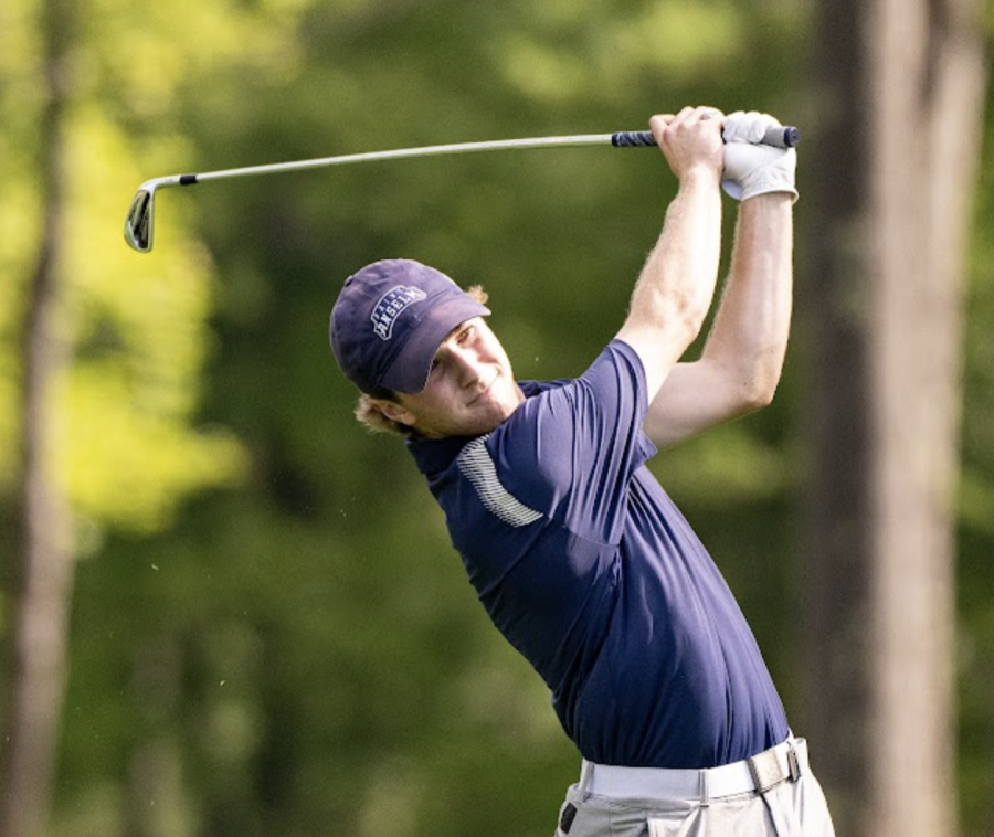 Senior captain Drew Semons watches his shot at the SNHU Golf Invitational