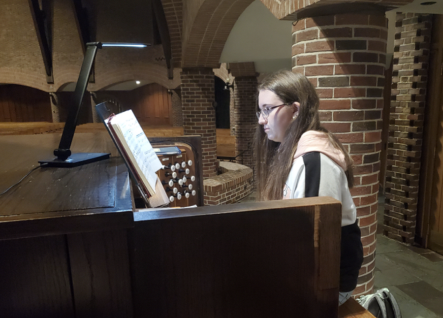Mariana Stauble practices the organ in the Abbey Church before her Decembersong performance.