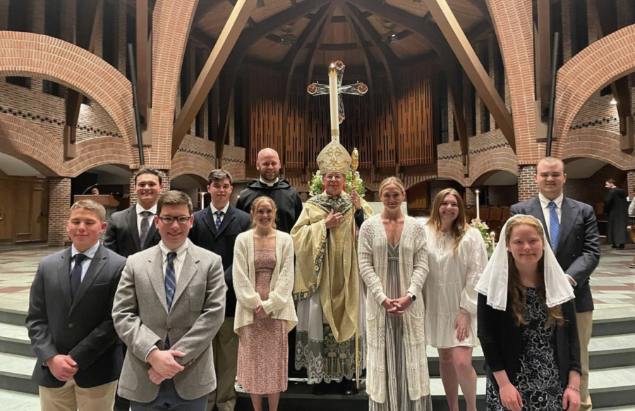 Students smile with Bishop Peter Libasci and Brother George Rumley, O.S.B. after receiving sacraments at RCIA Mass. (Courtesy / Campus Ministry) 