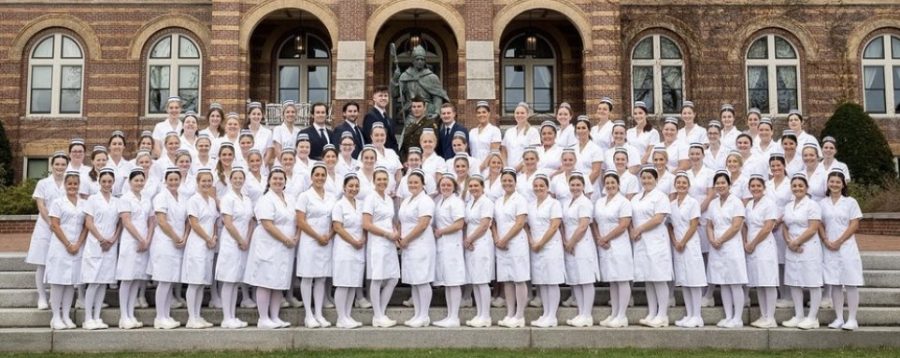 Saint Anselm senior nurses pose for a photo outside Alumni Hall after receiving their pins in the Abbey Church on April 29. (Courtesy / @anselmnursing)