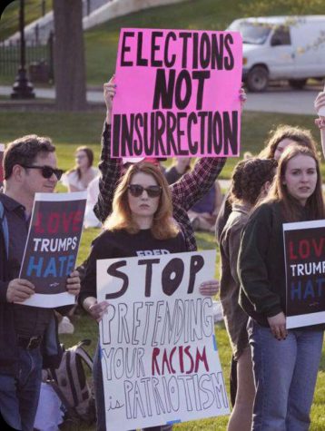 Lauren Batchelder visits Saint Anselm College to protest Trump town. (Courtesy/AP)