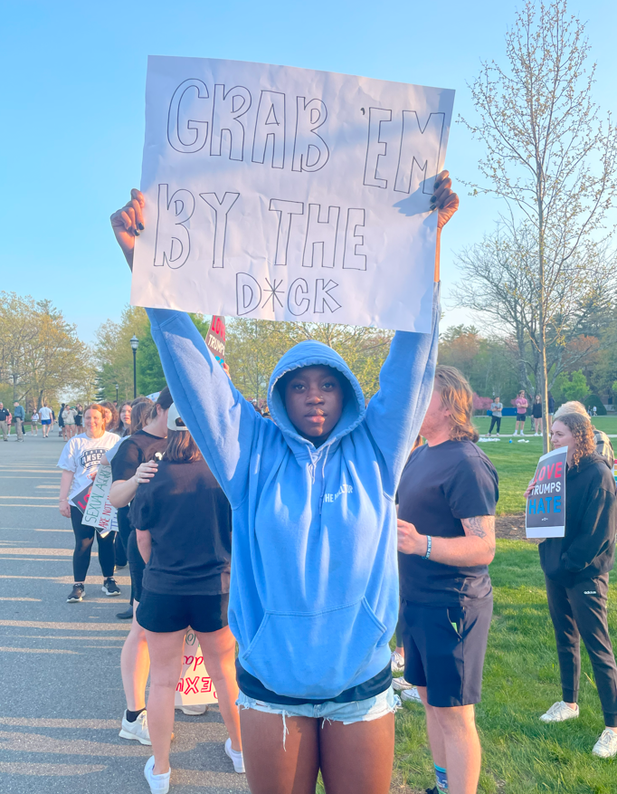Student protestor holds sign reading “grab ’em by the d*ck” (Photo by Tom Canuel)