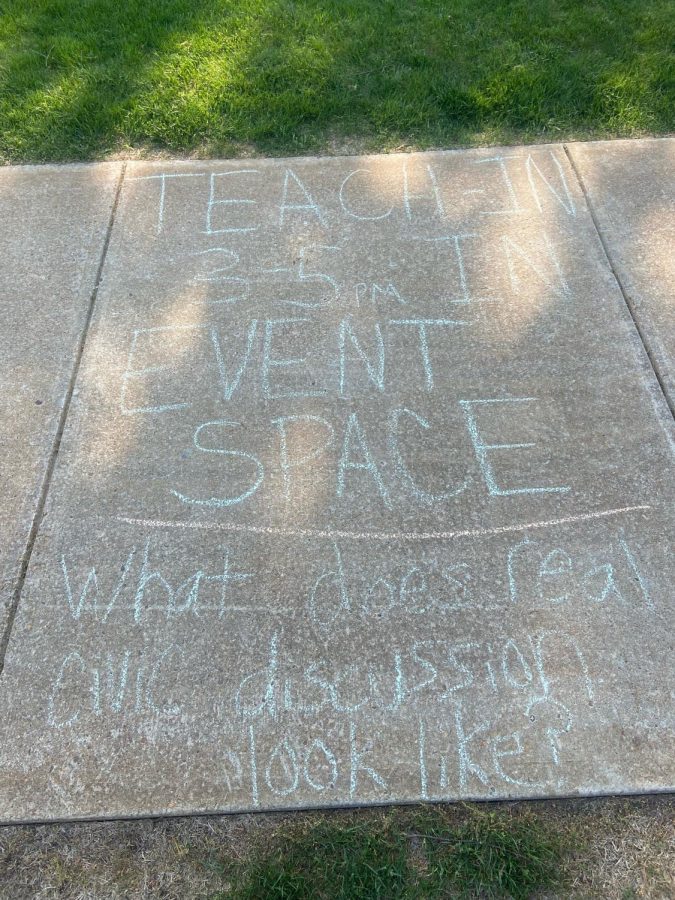 Students advertised the teach in using chalk around campus. (Photo by James Maloney)