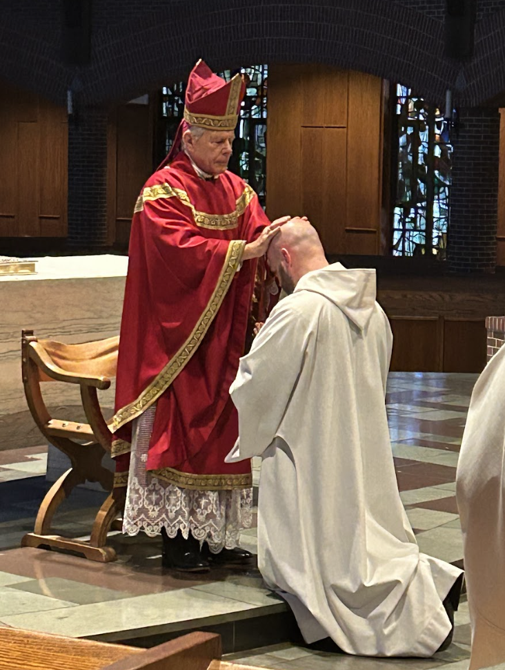 The Bishop lays hands on Fr. George.