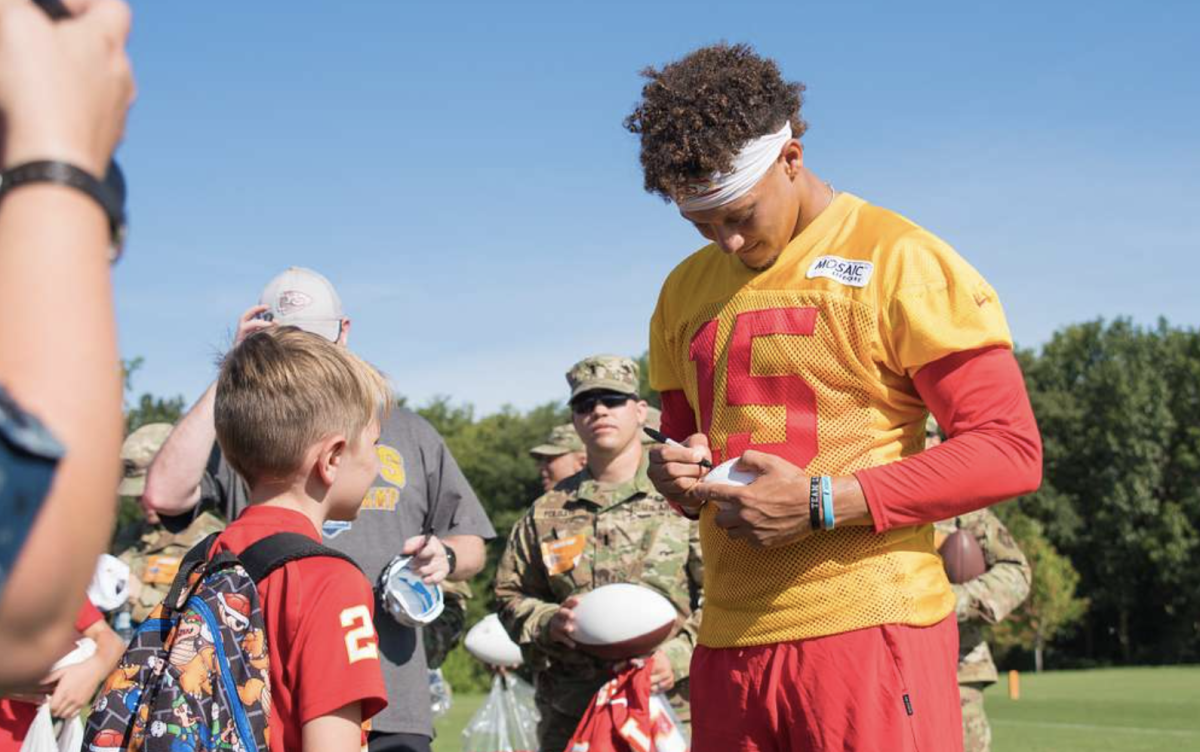 Chiefs Quarterback Patrick Mahomes signing autographs during training camp.