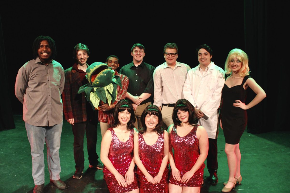 Cast of Little Shop of Horrors poses with the shows director Jesse Saywell