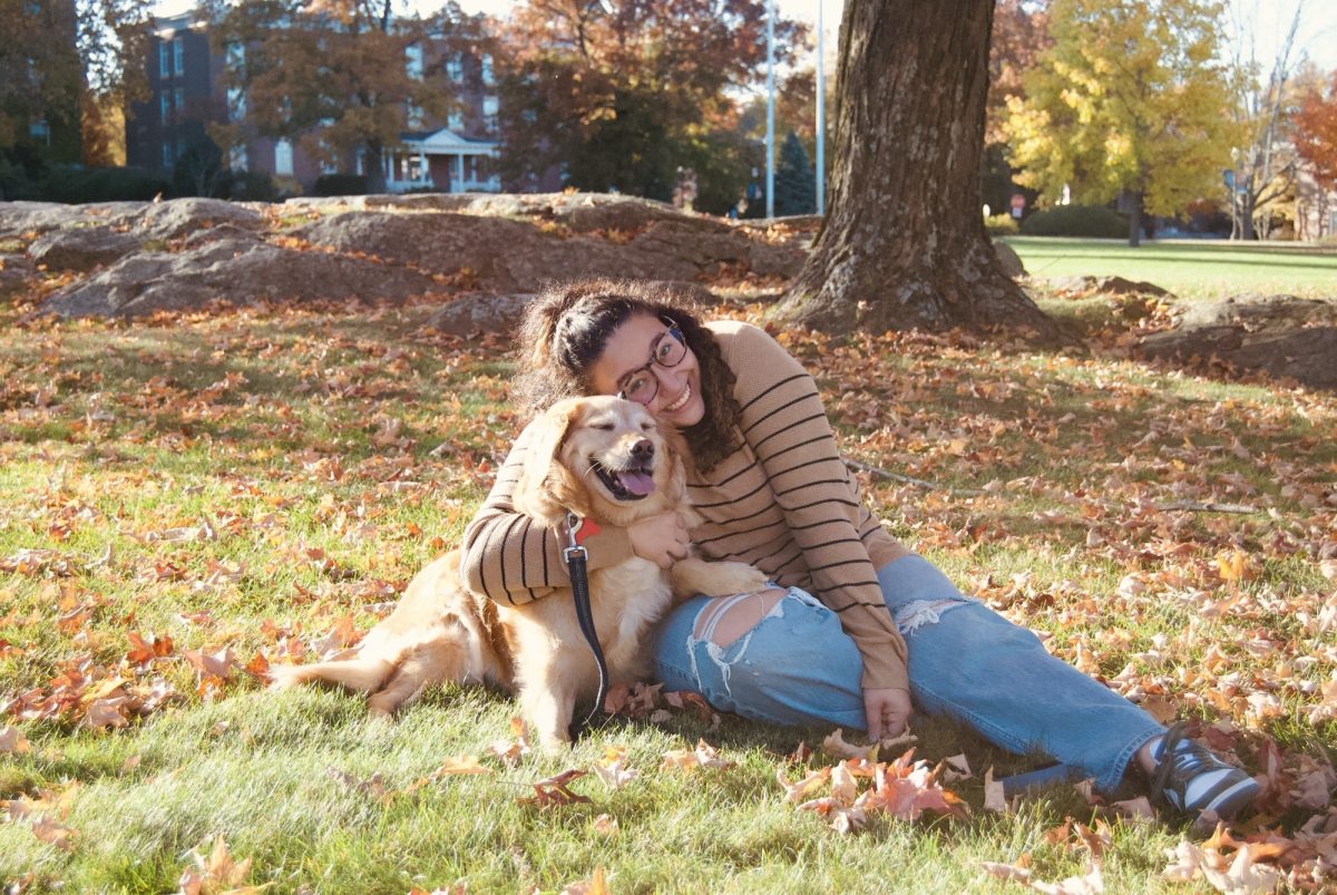 Sam Salas Santos poses with her dog, Beezly